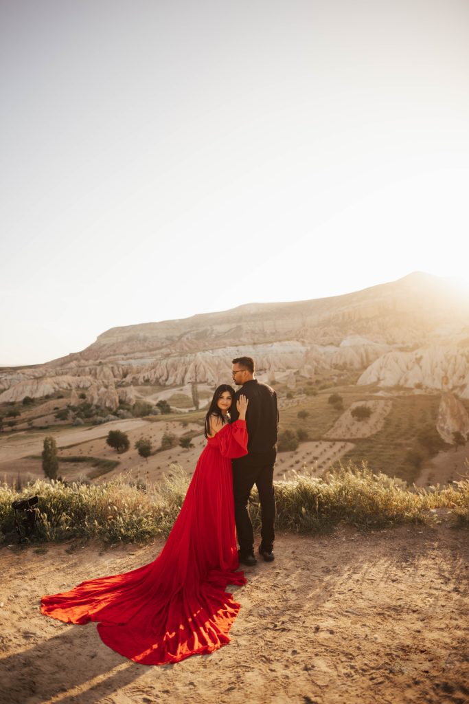 Couples photoshoot in Cappadocia overlooking valley with the sun rising