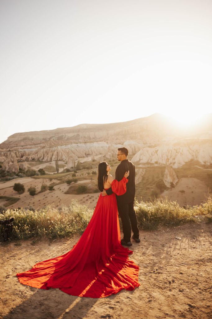 Couples photoshoot in Cappadocia overlooking valley with the sun rising