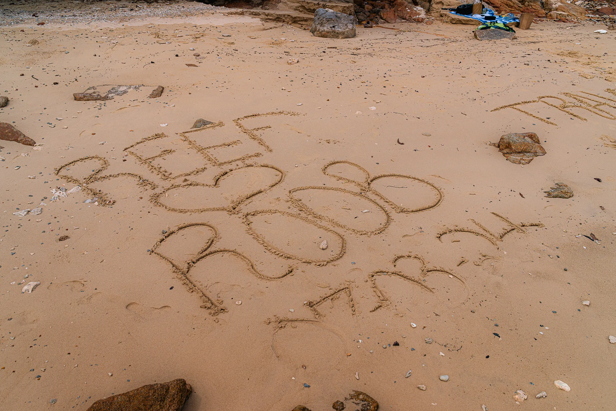 Aerial view of Tranquil Beach with the message 'Reef Heart Roob' etched into the sand. Also etched into the sand is the date of our stay.