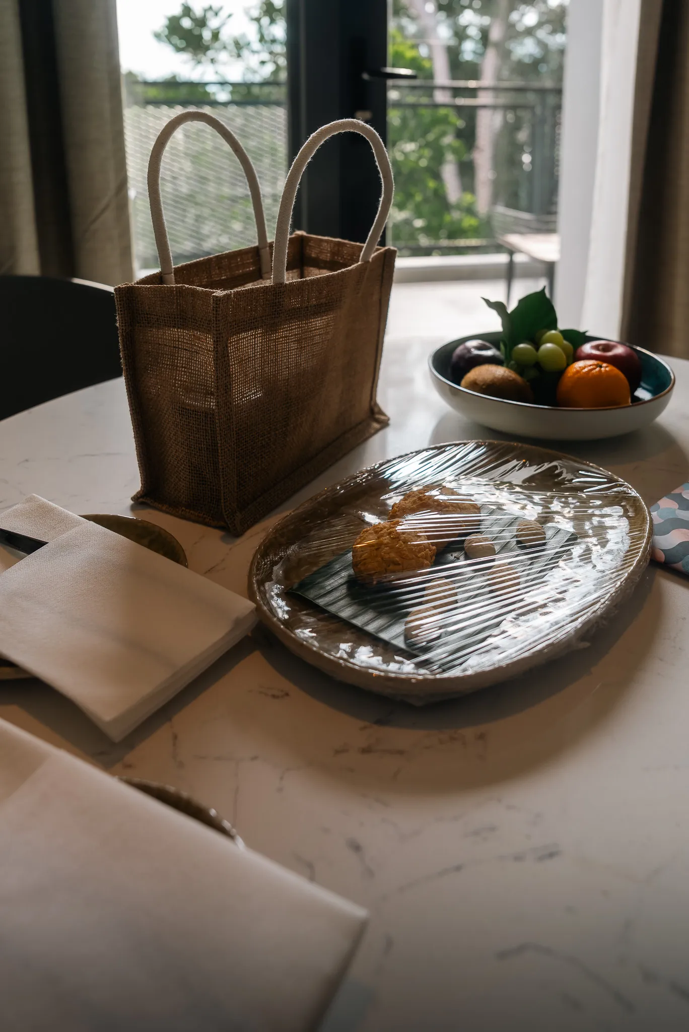Hotel room amenities at Perhentian Marriott Resort: fruit, pastries, and a welcome bag.