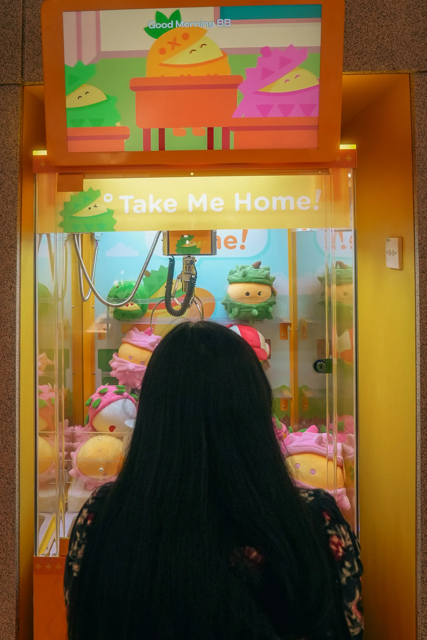 Aroob playing a claw crane game at DurianBB World, Kuala Lumpur