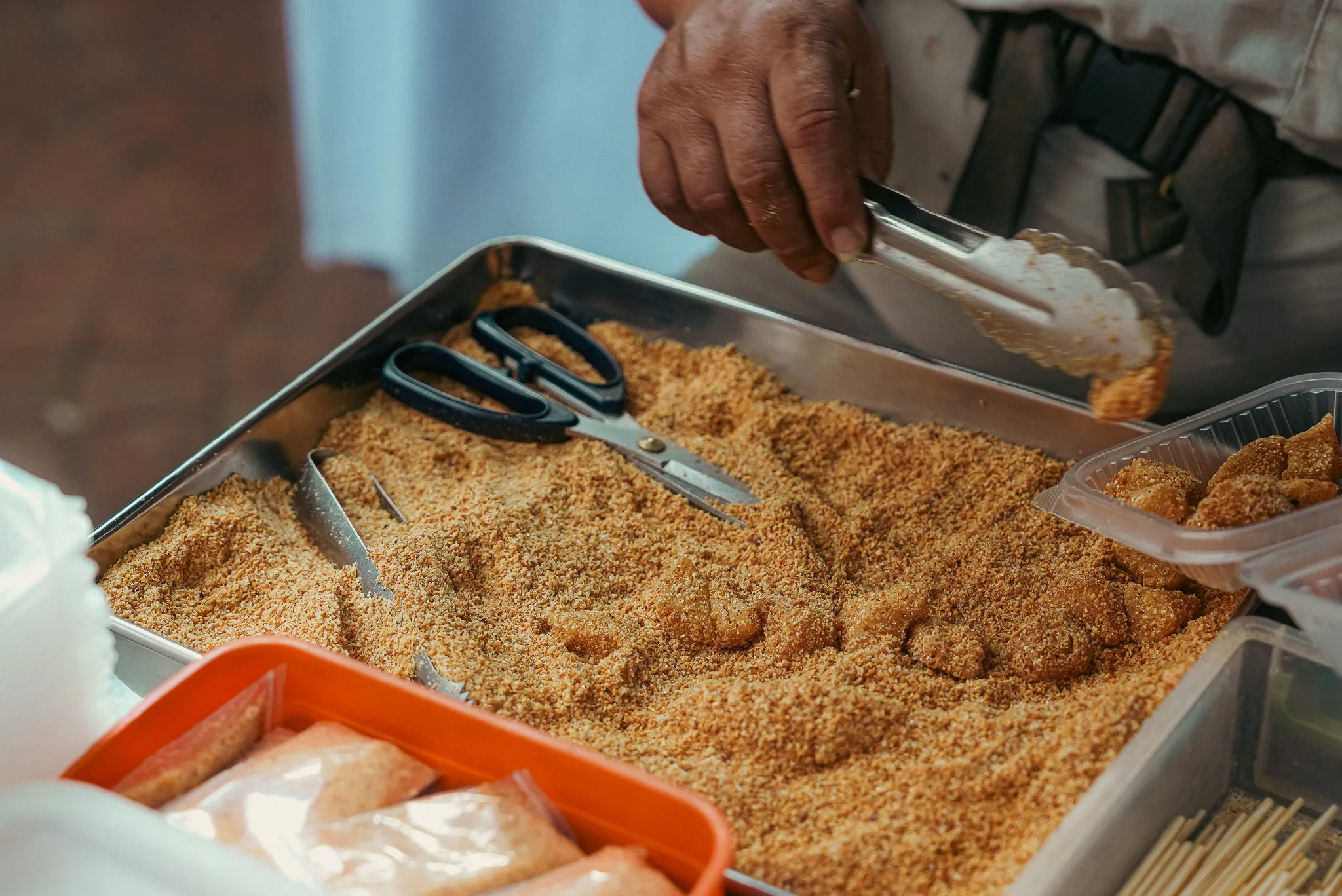 Fresh mochi being coated with ground peanut topping at No. 81 Mochi, Petaling Street, Kuala Lumpur