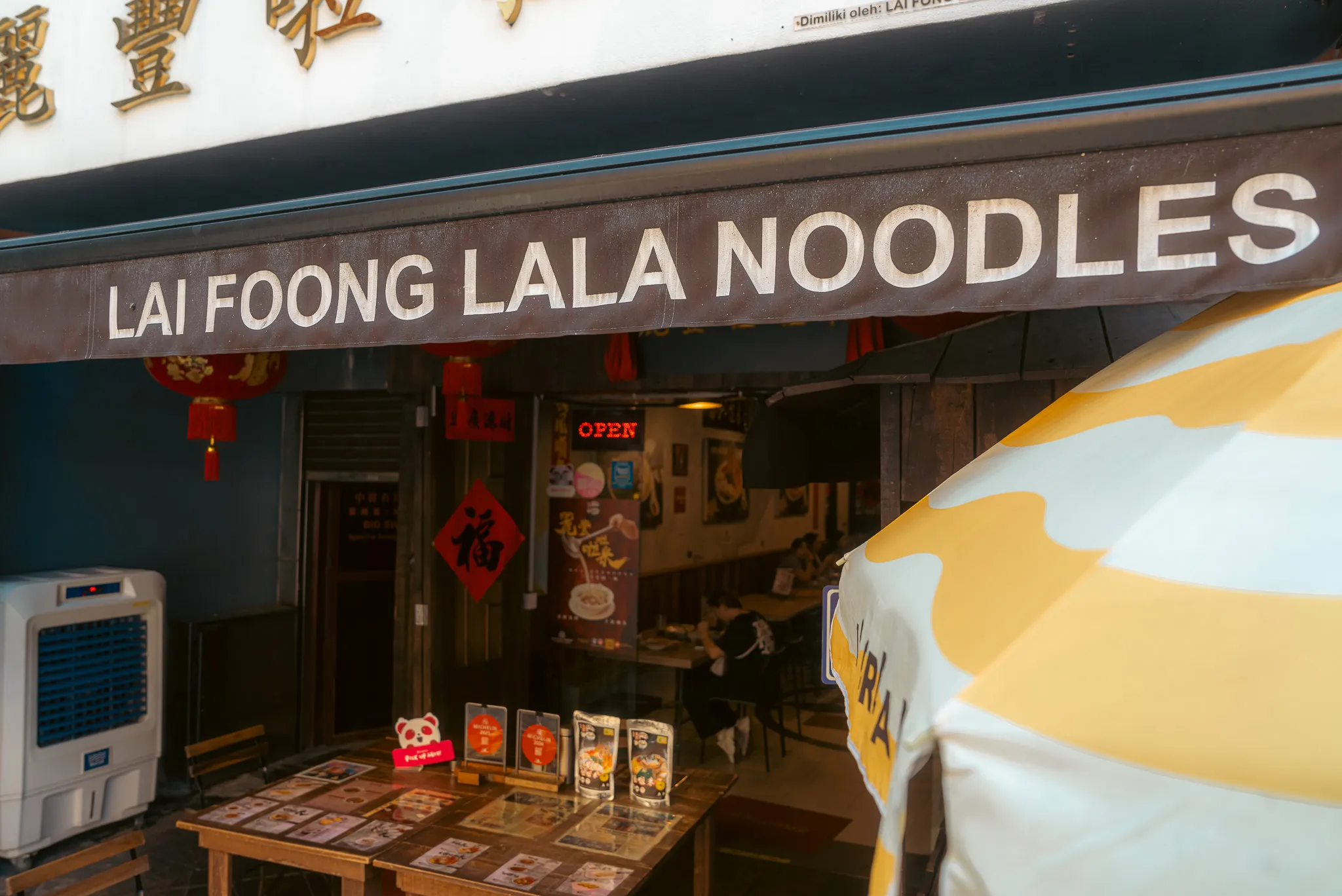 Lai Foong Lala Noodles storefront with banner, Kuala Lumpur, showing entrance and promotional materials